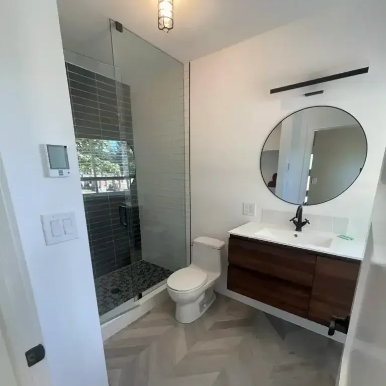 Modern bathroom renovation with herringbone tile in Hamilton, Ontario